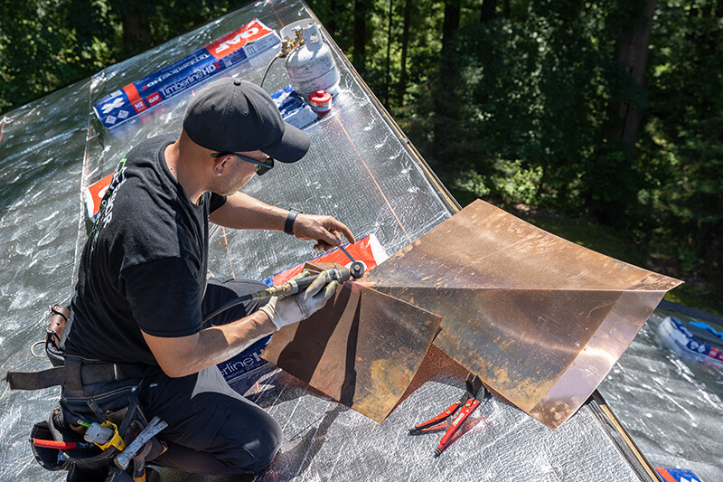 Experienced roofing repair contractors fixing a roof leak in Pennsylvania